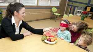 Angela Hasemann demonstrates how a blindfold can help kids try new foods.