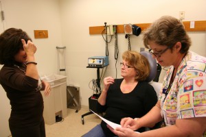 Liz Cook (left) interprets American Sign Language for patient Wanda Biser (center) and LPN Cynthia Napier during a dermatology appointment. 