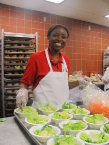 Junior volunteer Tina Njoroge making salads in Nutrition Services