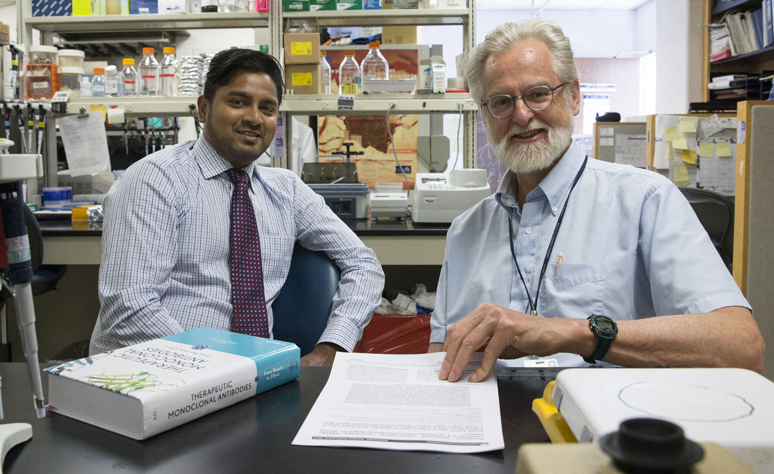 Biologists Eusebio Pires (left) and John Herr are looking at ways to treat cancer with fewer side effects.