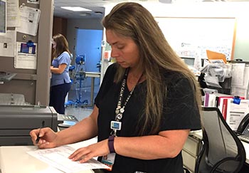 hospital nurse regina ragland working on paperwork