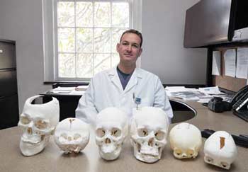 Jonathan Black with his 3D-printed skulls on his desk