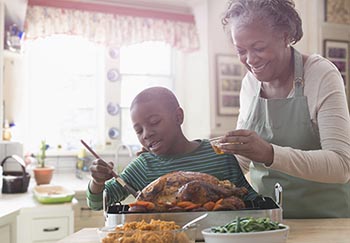 woman and her grandson keep dishes separate for Thanksgiving guests with food allergies
