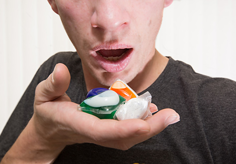 guy with mouth near tide pods