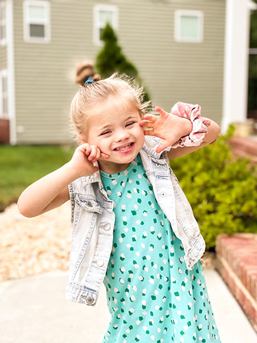 Lainey smiling, standing outside