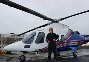 Leigh Critzer in front of helicopter