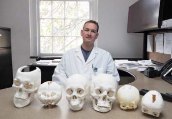 Dr. Jonathan Black with 3D-printed skulls
