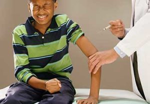 A preteen boy gets the HPV vaccine, which prevents cancer.