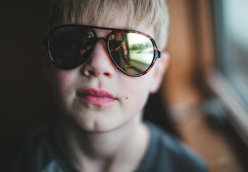 child with sun sensitivity wearing sunglasses