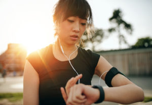 woman using a smartwatch to track her fitness activity