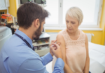 adult woman receiving a vaccine