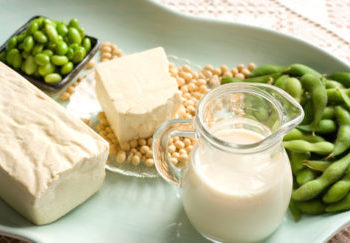 Soy products with soybean pods, tofu, milk on serving dish