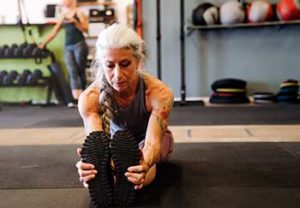 an older woman stretching may not know if her tattoos will cause cancer or not for years