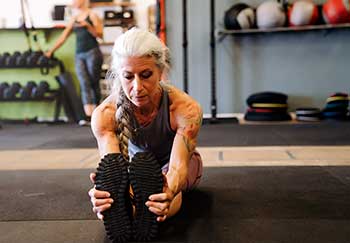 an older woman stretching may not know if her tattoos will cause cancer or not for years. Are tattoos bad?