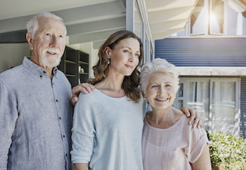 An older woman with her mother and father