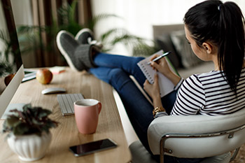 woman making personal preparedness list at home