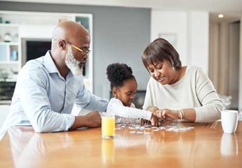 family doing jigsaw puzzle together