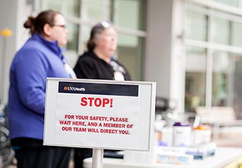 Signs & screening outside of the UVA hospital, which is part of a coronavirus clinical trial