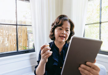 Senior woman participates in a virtual medical appointment