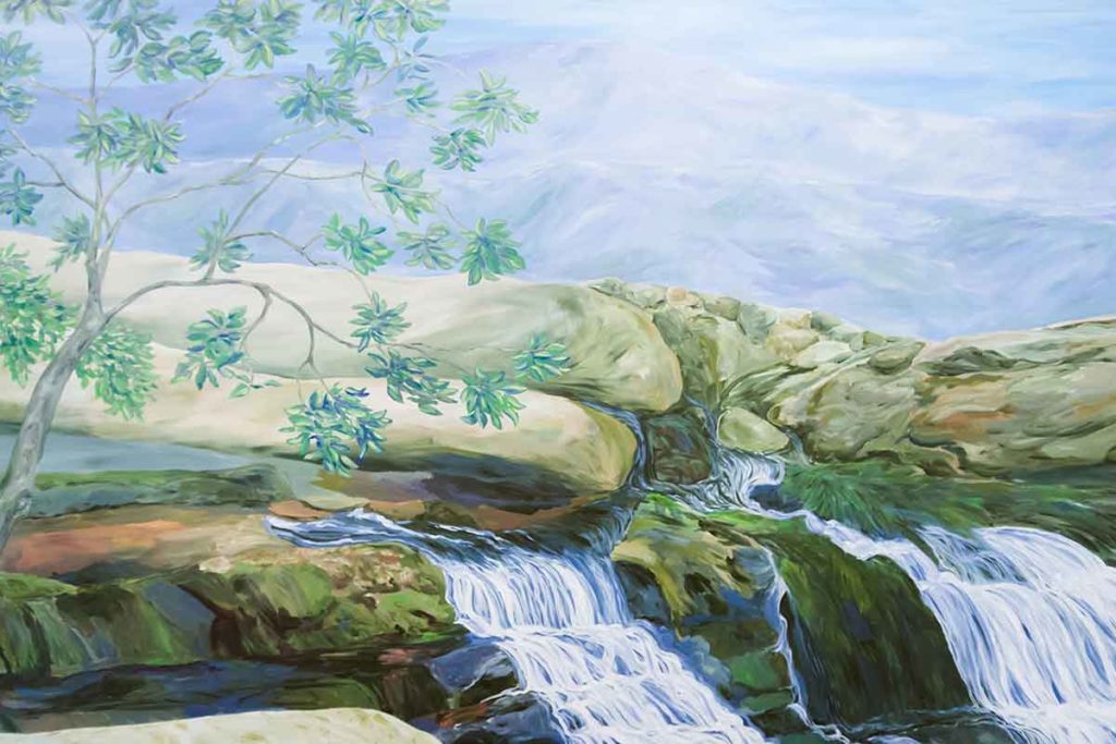 The mural includes images of waterfalls, trees and large rocks. 