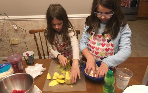 My daughters working together on the fruit salsa. 