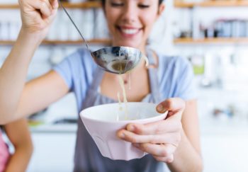 woman enjoying a bowl of her favorite comfort food