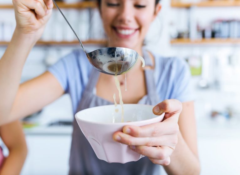 woman enjoying a bowl of her favorite comfort food