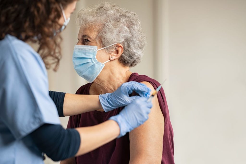 elderly woman getting the covid vaccine