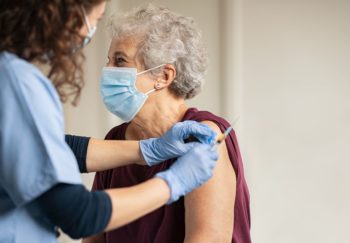 elderly woman getting the covid vaccine