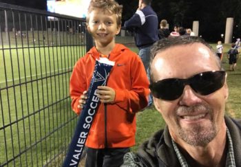 Jamie, an early-stage melanoma patient, and his son at a UVA soccer game