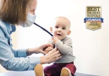 a baby grabbing a doctor's stethoscope during an exam. Badge on image says 'Best Children's Hospitals U.S. News & World Report Ranked in 5 Specialties'
