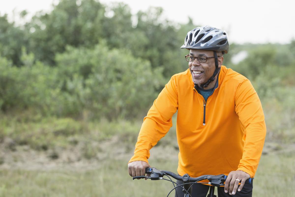 african-american-man-riding-bike-in-park-healthy-balance