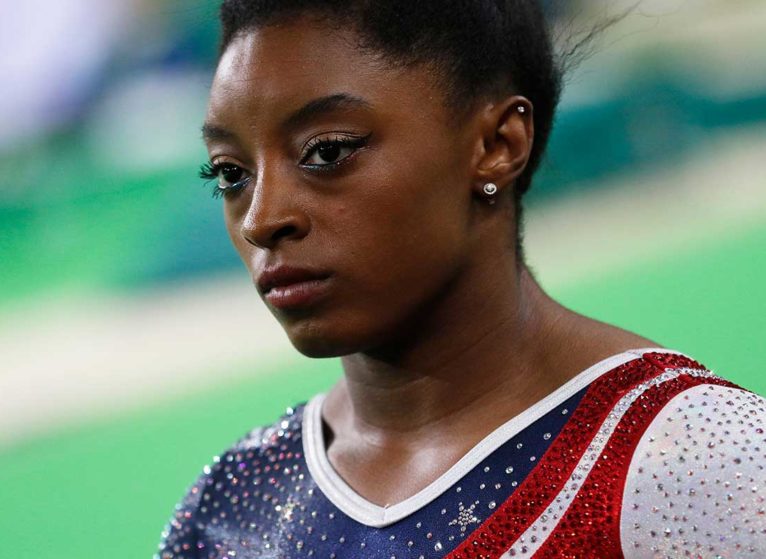 Gymnast Simone Biles wearing red, white and blue leotard