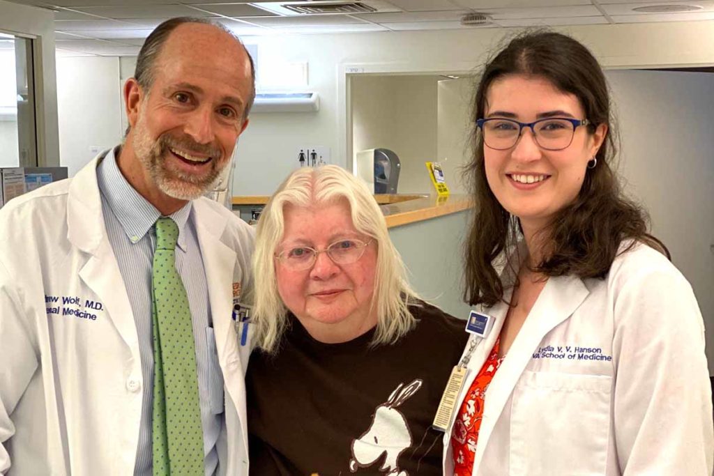 Three people standing in a clinic, part of the patient student partnership program