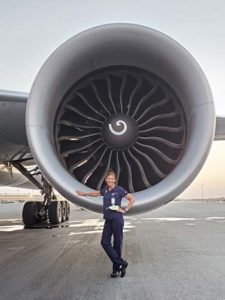Sara Sutherland, MD, standing in front of a plane