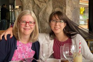 Jennifer Payne, MD, sitting at a table with her daughter Amanda