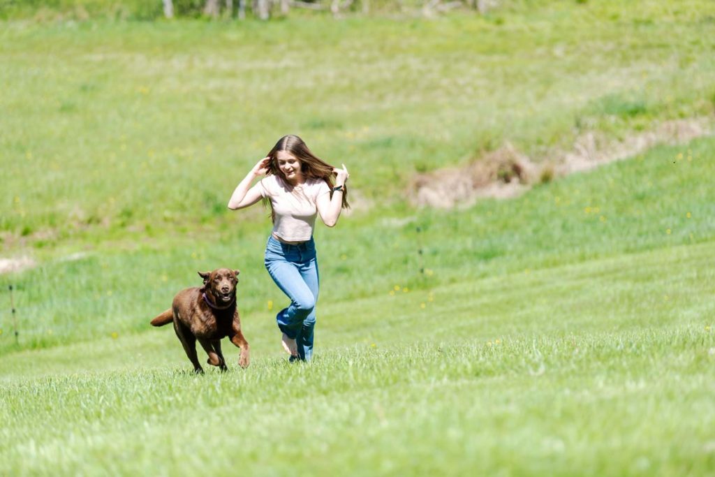childhood cancer survivor Anna running with her dog