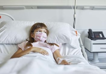 sick girl in hospital bed