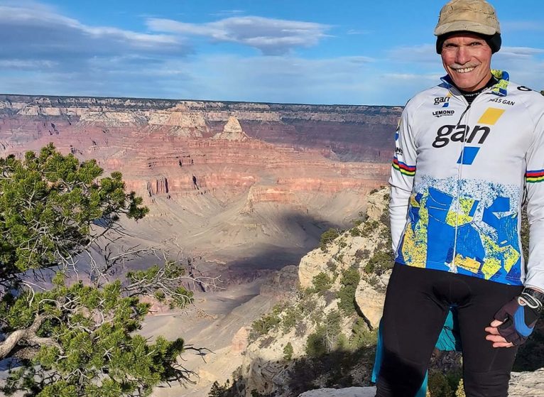 Bob Wright poses next to the Grand Canyon