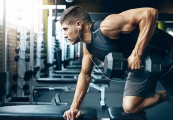 man working out in gym to gain muscle mass