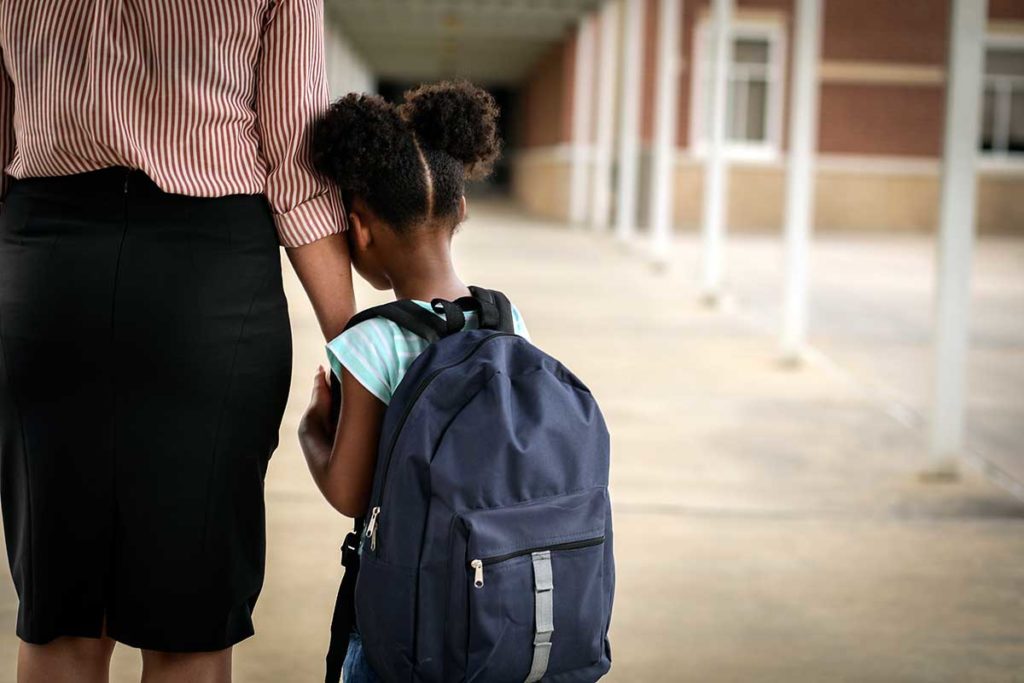 A child afraid of another school shooting leans on mom