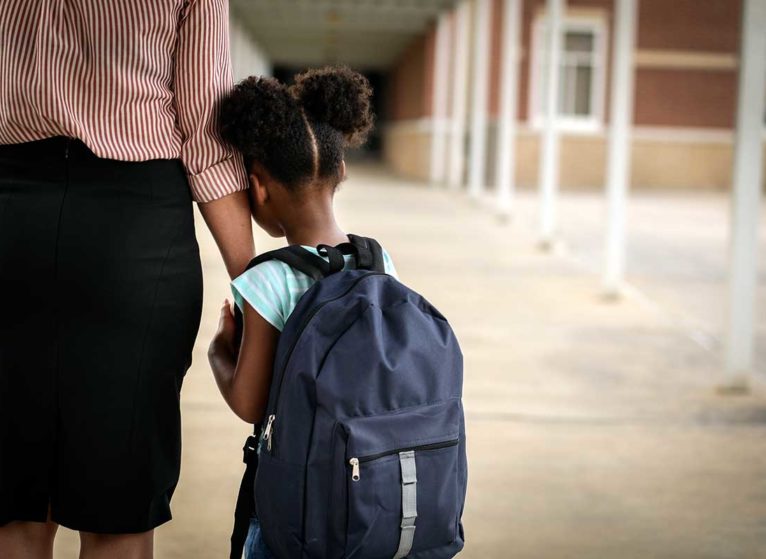 A child afraid of another school shooting leans on mom