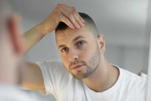 man looking in mirror