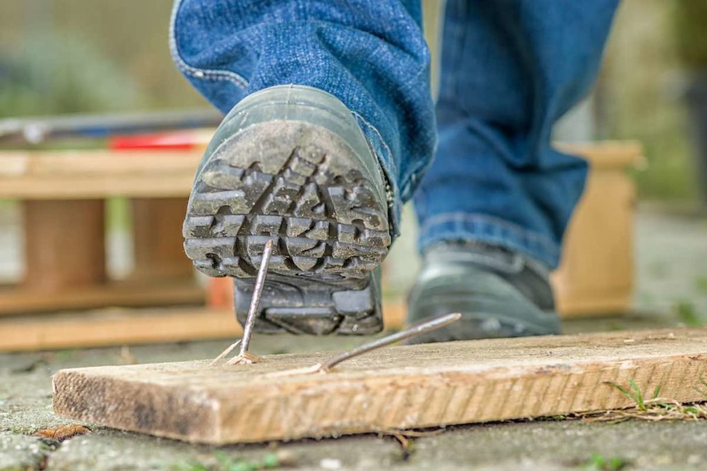 worker about to step on a nail