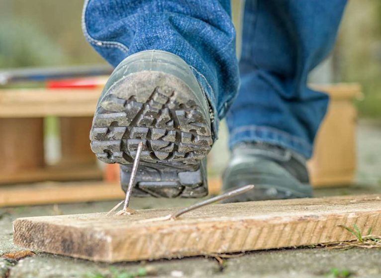 worker about to step on a nail