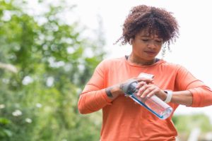 woman tracking steps with smartwatch