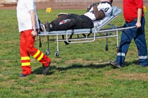 injured football player taken off field
