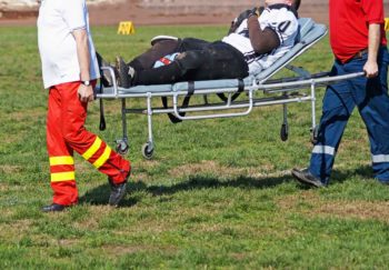 injured football player taken off field