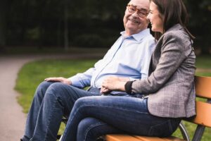 woman sitting on bench with grandfather atherosclerosis causes