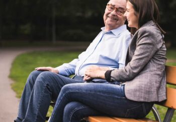 woman sitting on bench with grandfather atherosclerosis causes